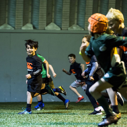 Tamariki rugby team running the length of the field image