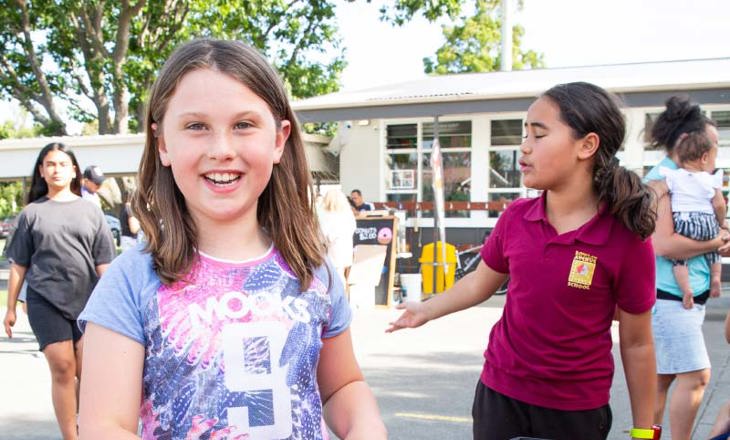 Girls grouping around a play pod at school
