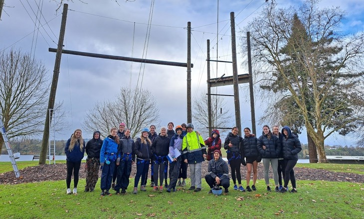 Group of young women in front of a high ropes course