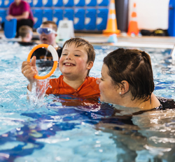 Mother and son playing in a pool