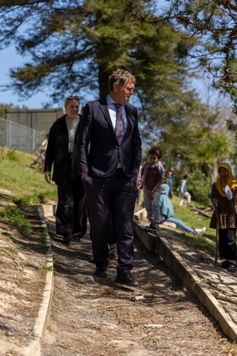 Man looking over the tamariki at play