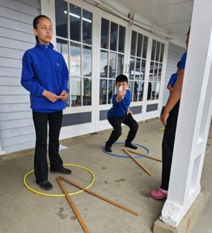 tamariki standing in a circle