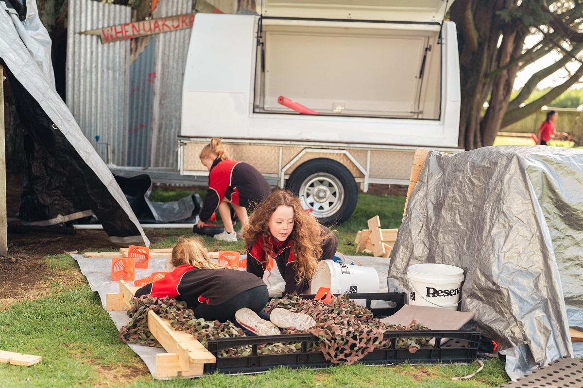 Tamariki playing with items from a Play Trailer