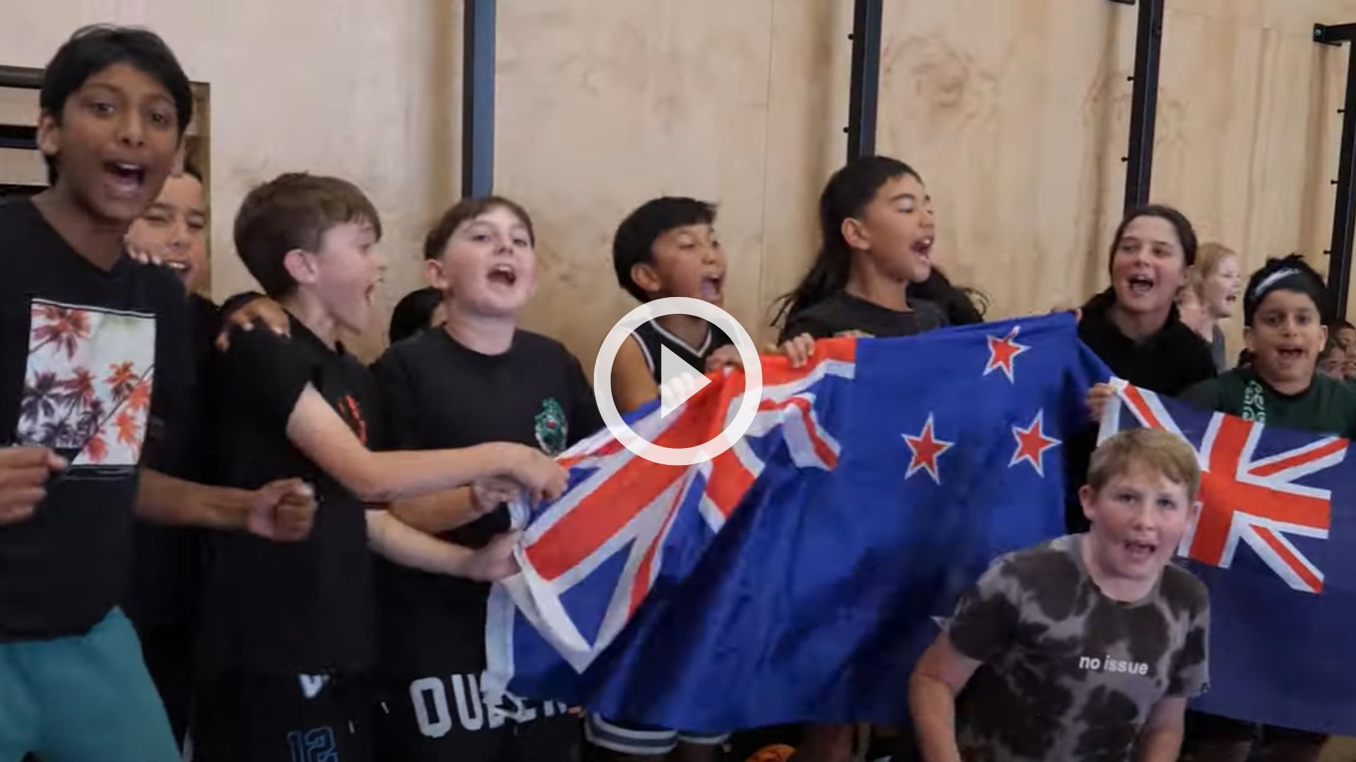 Group of tamariki cheering at the wheelchair rugby game